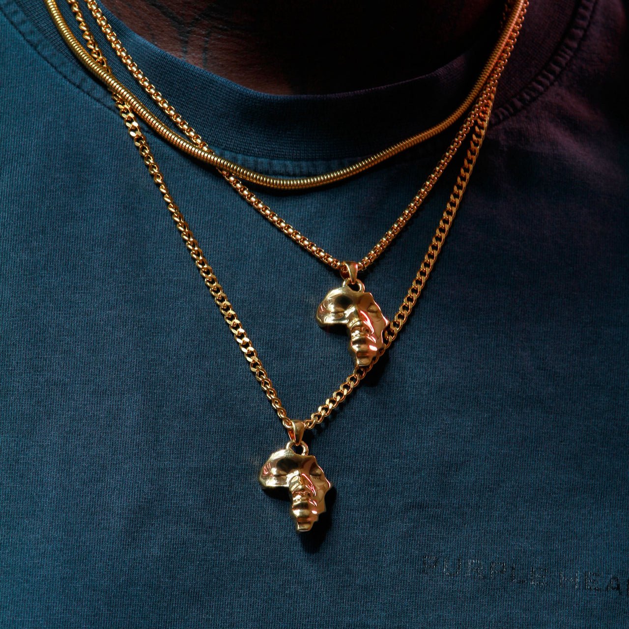 Gold Plated Africa Face Motherland Pendant Necklace with Cowrie Shell from NUJUAL, a black owned jewelry shop for men and women.