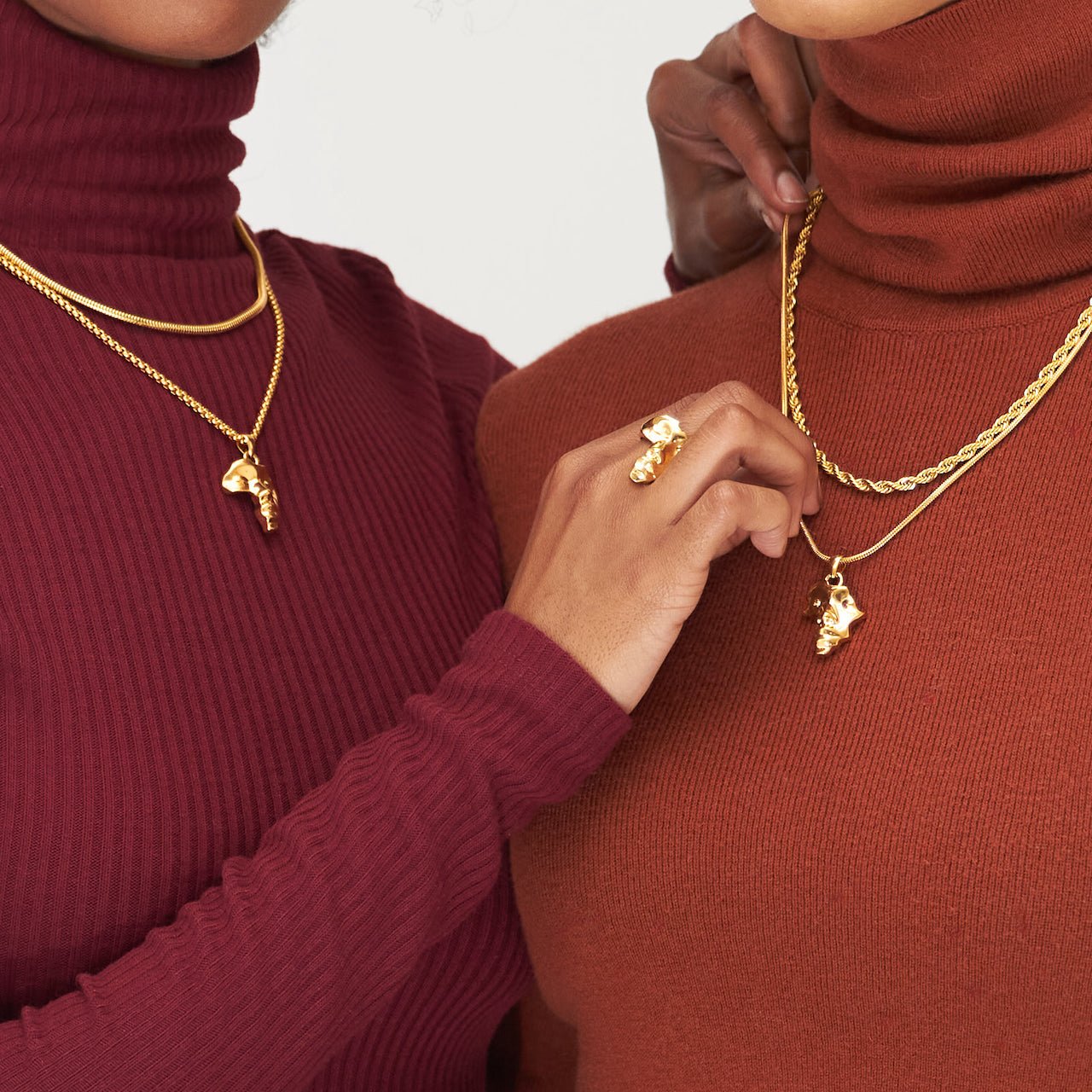 Gold Plated Africa Face Motherland Pendant Necklace with Cowrie Shell from NUJUAL, a black owned jewelry shop for men and women.